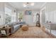 Comfortable living room featuring wainscoting, large windows, and a stylish area rug at 1535 Low Pk St, Mount Pleasant, SC 29464