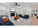 Bright living room with a fireplace, ceiling fan and one blue couch at 1535 Low Pk St, Mount Pleasant, SC 29464