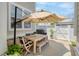 Inviting patio with a wood dining table set under a large umbrella for outdoor enjoyment at 1535 Low Pk St, Mount Pleasant, SC 29464