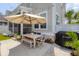 Outdoor patio dining with an umbrella, wood table, and a convenient grill for entertaining at 1535 Low Pk St, Mount Pleasant, SC 29464