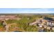 Aerial view of a community featuring homes, a school and lush green spaces at 154 Calm Water Way, Summerville, SC 29486