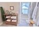 Bathroom storage shelves with towels, with a glimpse to a shower and window at 154 Calm Water Way, Summerville, SC 29486