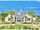 Charming community clubhouse with palm trees, well-manicured landscaping, and elegant architectural details, creating a welcoming gathering space at 154 Calm Water Way, Summerville, SC 29486