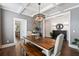 Elegant dining room with coffered ceilings, stylish light fixture, and ample seating at 154 Calm Water Way, Summerville, SC 29486