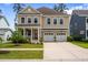 Charming two-story home featuring a welcoming front porch and a convenient two-car garage at 154 Calm Water Way, Summerville, SC 29486
