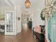 Inviting foyer with shiplap walls, hardwood floors, and a decorative wreath on the front door at 154 Calm Water Way, Summerville, SC 29486