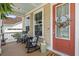 Charming front porch with rocking chairs and stylish decor, creating a welcoming entrance at 154 Calm Water Way, Summerville, SC 29486