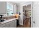 Charming kitchen with gray cabinets, marble countertops, and stainless steel wine fridge at 154 Calm Water Way, Summerville, SC 29486