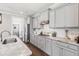 Well-lit kitchen featuring ample gray cabinetry, stainless steel appliances, and marble countertops at 154 Calm Water Way, Summerville, SC 29486