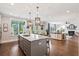 Open concept kitchen with center island and eat in counter and hardwood floors at 154 Calm Water Way, Summerville, SC 29486