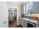 Charming kitchen with gray cabinets, marble countertops, and stainless steel wine fridge at 154 Calm Water Way, Summerville, SC 29486