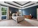 Stylish main bedroom featuring trey ceiling, two windows, and modern accents at 154 Calm Water Way, Summerville, SC 29486