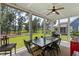 Relaxing screened-in porch with dining table and scenic backyard views at 154 Calm Water Way, Summerville, SC 29486