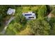 An overhead view of a home with solar panels on the roof amid a lush, green landscape at 162 Whippoorwill Dr, Summerville, SC 29483