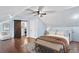 Bright bedroom with slanted ceilings, hardwood floors, and a barn door to the en suite bathroom at 162 Whippoorwill Dr, Summerville, SC 29483