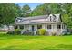 Charming two-story home featuring a welcoming front porch, solar panels, and a lush green lawn at 162 Whippoorwill Dr, Summerville, SC 29483