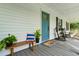 Inviting front porch with rocking chairs, bench, and a vibrant blue front door at 162 Whippoorwill Dr, Summerville, SC 29483