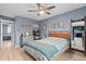 Cozy bedroom featuring a ceiling fan, ample natural light and blue walls for a calming atmosphere at 1713 Boone Hall Dr # 1082, Charleston, SC 29407