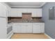This kitchen features white appliances, cabinetry, stainless steel sink and a light speckled countertop at 1713 Boone Hall Dr # 1082, Charleston, SC 29407