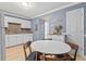 Open-concept kitchen and breakfast nook with white cabinets and stainless steel appliances offer a bright and welcoming space at 1713 Boone Hall Dr # 1082, Charleston, SC 29407
