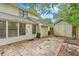 Backyard shows the rear exterior of the house with a paved patio and some greenery at 18 Indigo Ln, Goose Creek, SC 29445