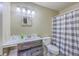 This bathroom features a vanity with a granite countertop, a mirror and a checkered shower curtain at 18 Indigo Ln, Goose Creek, SC 29445