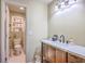 Bathroom featuring wood vanity, black faucet, white sink, open door to toilet and shower at 18 Indigo Ln, Goose Creek, SC 29445