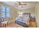 Bedroom featuring a ceiling fan, window with a chair and a bed with floral bedding at 18 Indigo Ln, Goose Creek, SC 29445