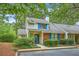 Charming two-story home with brick accents, blue shutters, and a well-maintained, lush landscaped yard at 18 Indigo Ln, Goose Creek, SC 29445
