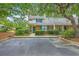 Charming townhouse with blue shutters and lush landscaping, offering a blend of comfort and curb appeal at 18 Indigo Ln, Goose Creek, SC 29445