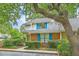 Two-story home featuring brick accents and blue shutters, surrounded by mature trees and landscaping at 18 Indigo Ln, Goose Creek, SC 29445