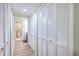 Hallway featuring multiple closet doors and a view of the attached bathroom at 18 Indigo Ln, Goose Creek, SC 29445