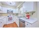 Bright kitchen boasts stainless steel appliances, white cabinetry, and durable countertops at 18 Indigo Ln, Goose Creek, SC 29445