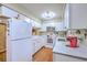 Bright kitchen with white cabinets, modern appliances, hardwood floors, and ample counter space at 18 Indigo Ln, Goose Creek, SC 29445