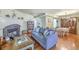 Comfortable living room with a fireplace, sofa, hardwood floors, and a view of the dining area at 18 Indigo Ln, Goose Creek, SC 29445