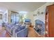 Inviting living room featuring hardwood floors, a fireplace, a comfortable sofa, and access to a patio at 18 Indigo Ln, Goose Creek, SC 29445