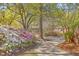 Picturesque street view with flowering bushes, trees, and homes showcasing a tranquil and scenic neighborhood at 18 Indigo Ln, Goose Creek, SC 29445