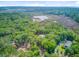 Aerial view of the property showcasing the surrounding wooded area and marsh at 18 Tupelo Trl, Edisto Island, SC 29438