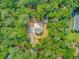 Drone shot highlighting home nestled among trees, complemented by a hot tub and landscaping at 18 Tupelo Trl, Edisto Island, SC 29438