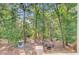 Aerial view of backyard featuring mature trees, a fire pit area, and seating at 18 Tupelo Trl, Edisto Island, SC 29438