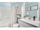 Well-lit bathroom with white vanity, modern fixtures, neutral shower curtain, and ample storage for bath essentials at 18 Tupelo Trl, Edisto Island, SC 29438