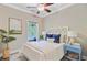Cozy bedroom with natural light, ceiling fan, stylish decor, and a view of outdoor greenery at 18 Tupelo Trl, Edisto Island, SC 29438