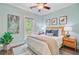 Charming bedroom featuring a comfortable bed, ceiling fan, stylish decor, and natural light from a nearby window at 18 Tupelo Trl, Edisto Island, SC 29438