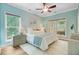 Bright bedroom with many windows allowing natural light, ceiling fan, stylish decor, and a view of the outside deck at 18 Tupelo Trl, Edisto Island, SC 29438