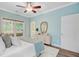 Relaxing bedroom featuring bright colors, stylish decor, a ceiling fan, ensuite access, and a view of the outside deck at 18 Tupelo Trl, Edisto Island, SC 29438