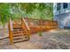 Wooden deck features stairs and lattice providing an inviting outdoor space for relaxing and entertaining guests at 18 Tupelo Trl, Edisto Island, SC 29438