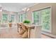 Dining area with large windows, with a wicker dining set, and a light filled living space at 18 Tupelo Trl, Edisto Island, SC 29438