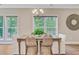 Comfortable dining area with a chandelier, offering serene views from surrounding windows at 18 Tupelo Trl, Edisto Island, SC 29438
