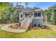 Charming two-story beach house with a welcoming porch and lush landscaping at 18 Tupelo Trl, Edisto Island, SC 29438