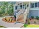 Beautiful elevated home with wood stairs, landscaping, and coastal charm at 18 Tupelo Trl, Edisto Island, SC 29438